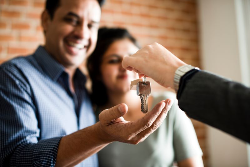 Happy couple accepting the keys to their new home
